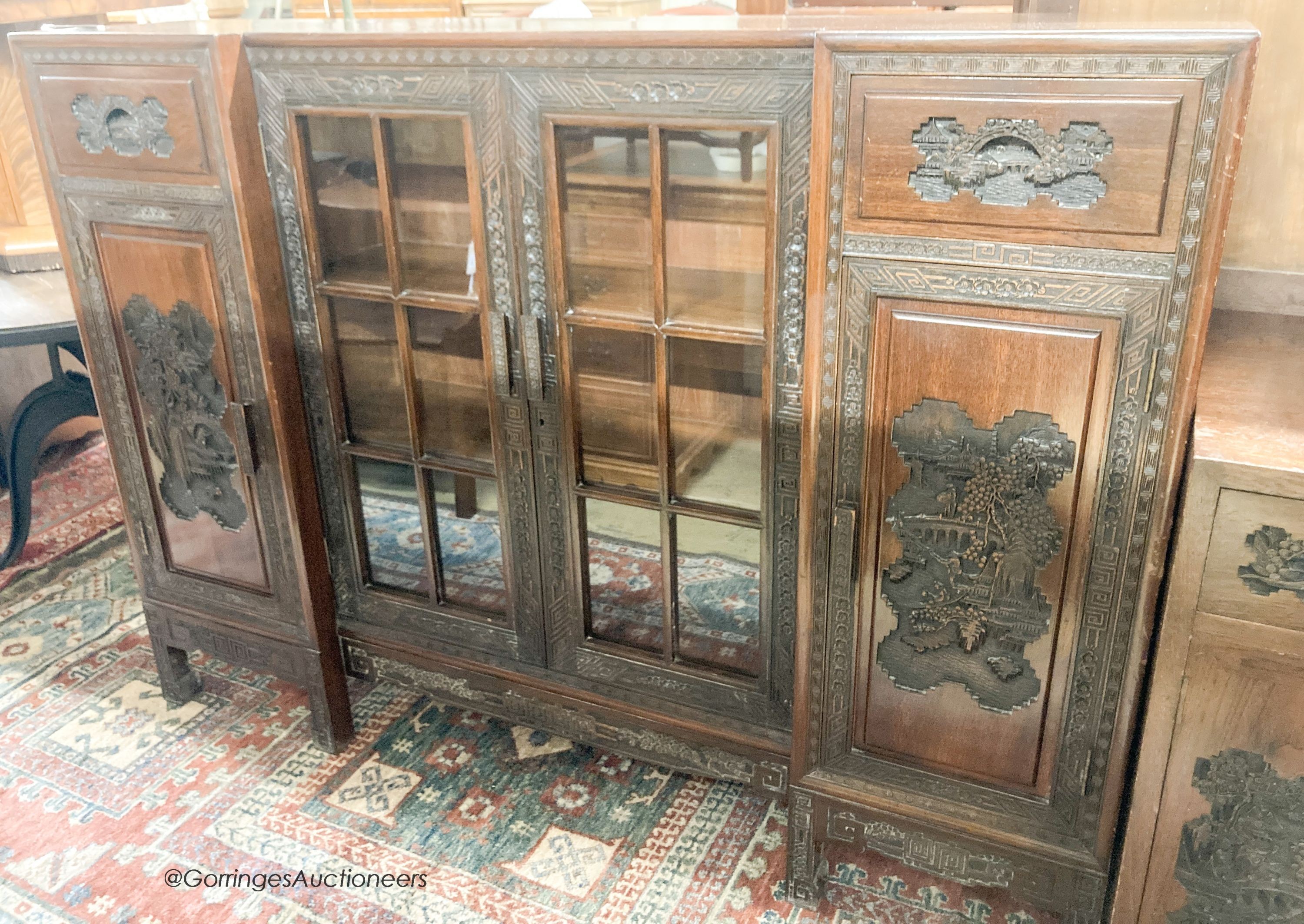 A Chinese carved hardwood breakfront display cabinet, glazed door, length 152cm, depth 33cm, height 112cm